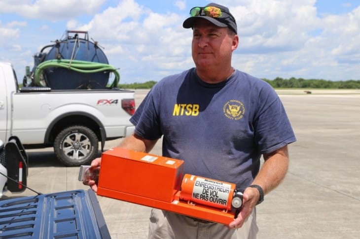 NTSB investigator Dan Boggs holds the flight data recorder recovered from the Miami Air International Boeing 737 800 that overran the runway at Naval Air Station Jacksonville