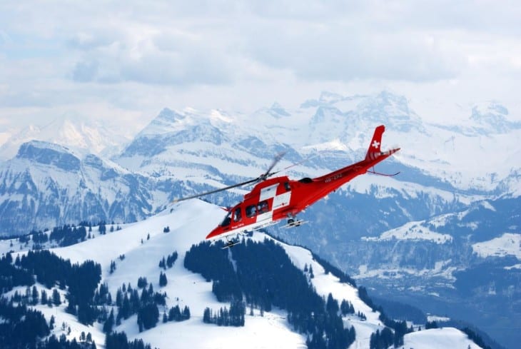 Helicopter over snowy mountain range